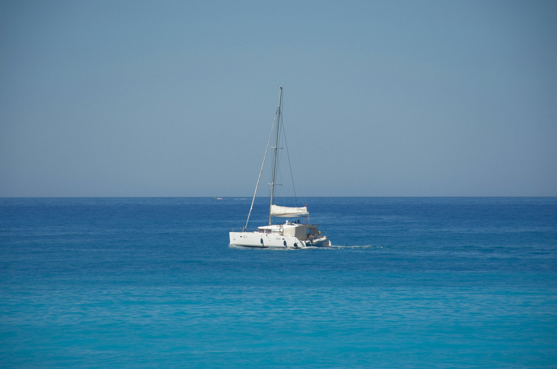 Luxury sailing catamaran at sunset
