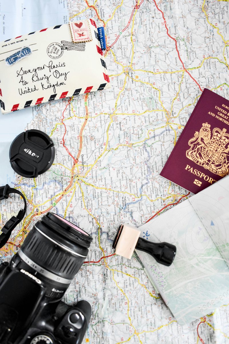 Travel planning with a map, passport and camera