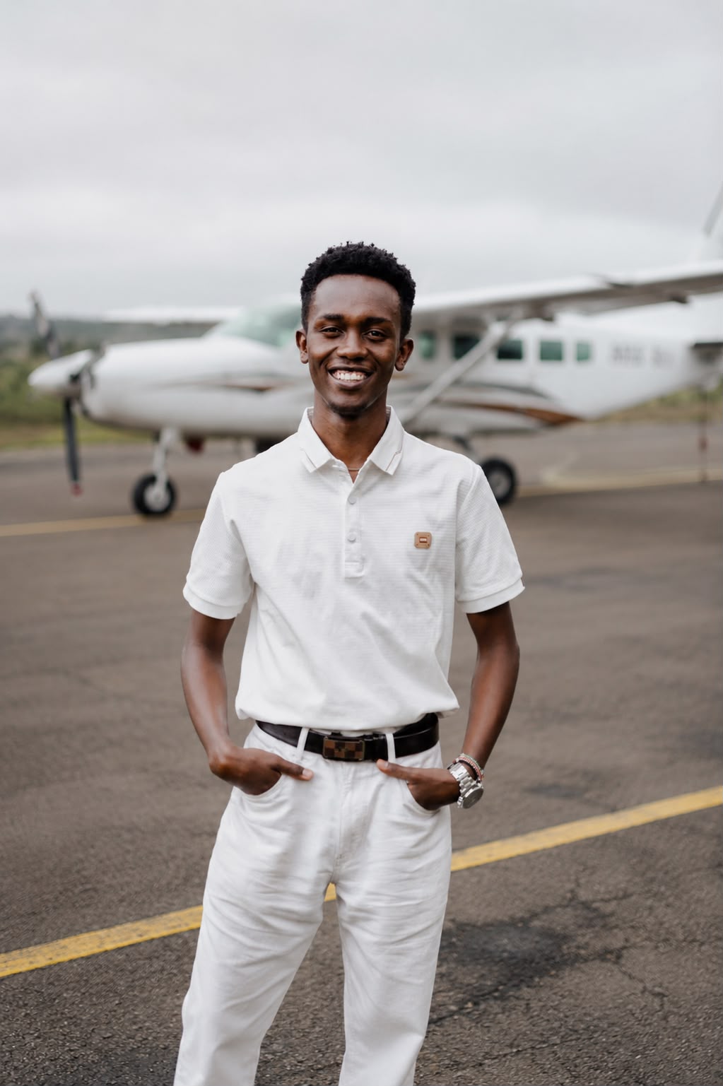Kelly Munene, Founder of Nene Charters, standing in front of a Cessna Caravan